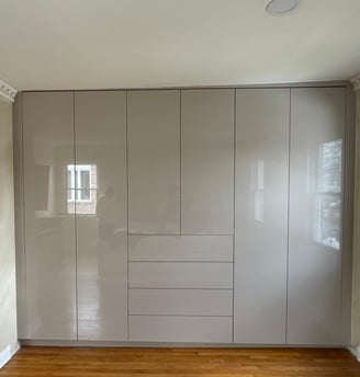 a room with a wooden floor and a white cupboard