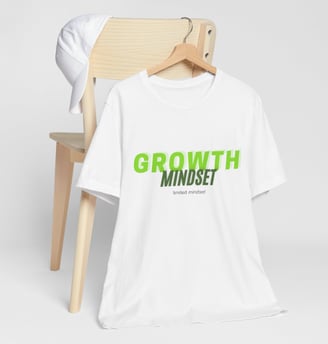 a white t - shirt with a green and black growth mindset