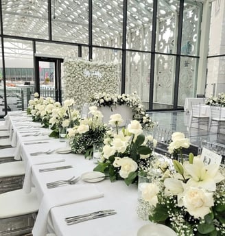 Wedding backdrop with white rose centerpieces 