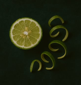 a slice of bergamot with a spiraling of bergamots on a green background