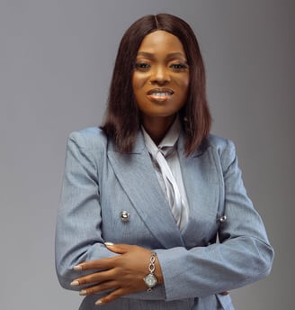 An image of a woman in grey suit, smiling.