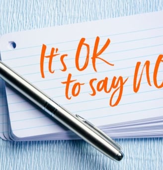 a pen and on a notebook with the words it's ok to say no