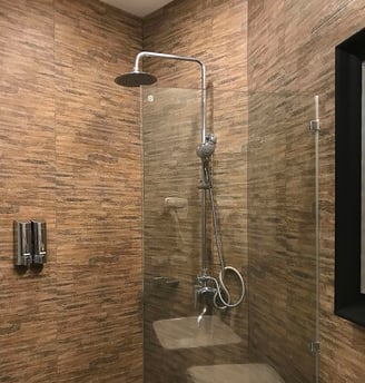 a bathroom with a shower and a shower