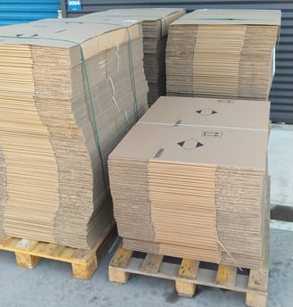 a stack of cardboard boxes on pallets