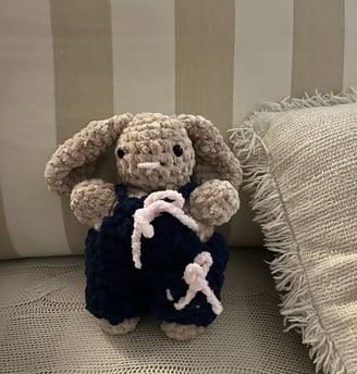 a plush bunny is sitting on a couch