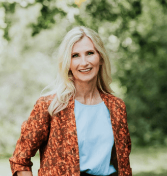 Portrait photo of Tina Rush founder of Outfluential NZ. Blonde woman smiling in outdoor setting. 