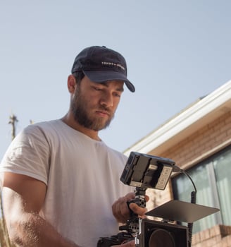 a man in a white shirt and a camera