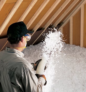 a man in a hat and gloves is holding insulation