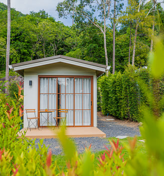 A vacation tiny home at The Boulder Phangan with private terrace, garden. and lush forest.
