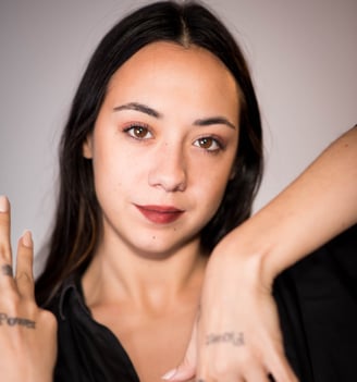 a woman with tattoos on her hands and a tattoo on her hand