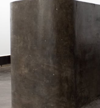 a large concrete block sculpture in a museum