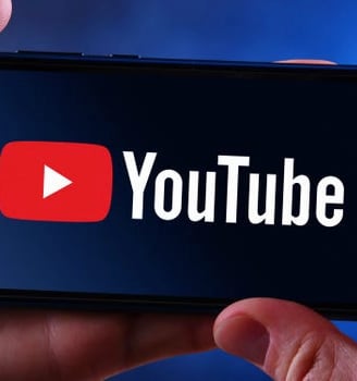 a person holding a phone with the youtube youtube logo on it