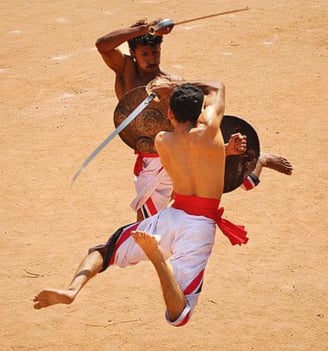 The traditional martial art of kalari payattu being performed by its artists at a sandy beach