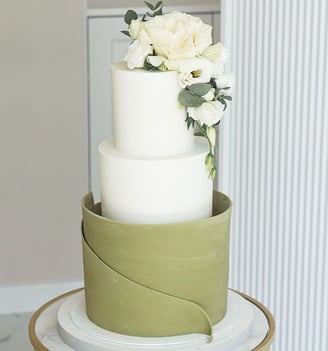 a cake with white flowers on top of a table