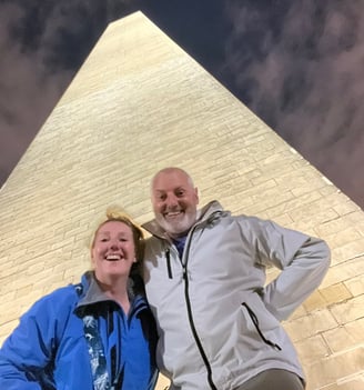 a man and woman standing in front of a monument in Washington DC