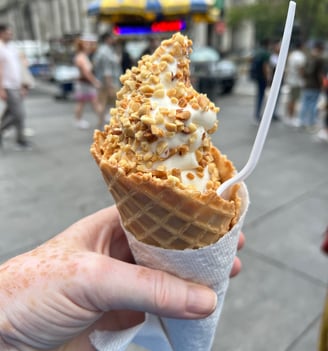Large Ice Cream in a cone topped with nuts
