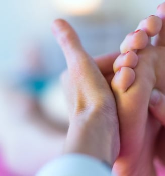 a person holding their hands up to their feet