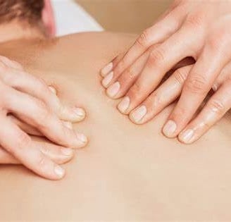 a man is shown with hands on his back
