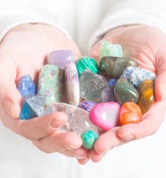 a person holding a bunch of rocks in their hands