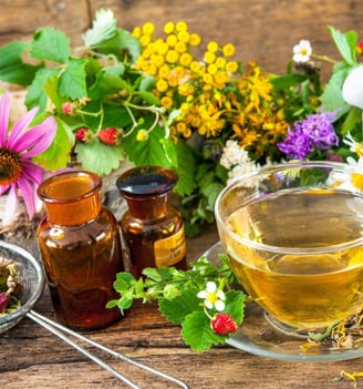 a cup of tea and a teapot with flowers
