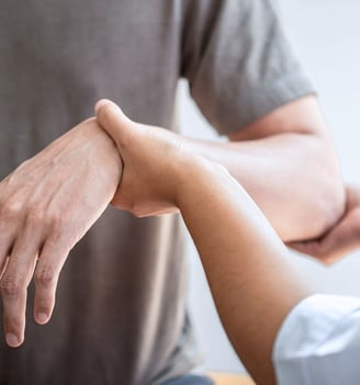 a man holding a woman's hand while she is holding her hand