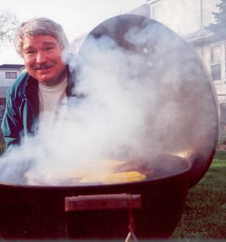 some crazy guy checking on the brats to see if they're done