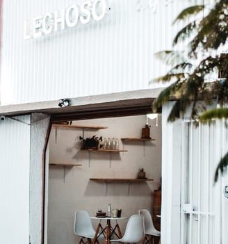 a white building with a table and chairs