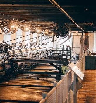 A large number of old weaving machines in a mill