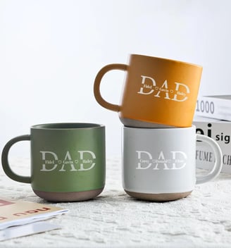 a couple of mugs with dad written word