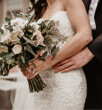 a cis couple on their wedding day, featuring the colour schemr through the brides bouquet of flowers