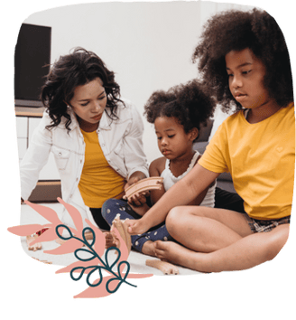 a family sitting on the floor of a living room