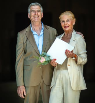 a man and woman standing next to each other on their wedding day 