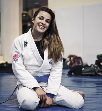 Remi White, smiling on the mat