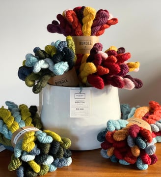 Blue Sky Fibers Warm and Cool Bundles of mini yarn hanks in a white vase arranged like a bouquet