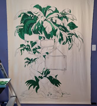 A linen tapestry mural in progress with building green colors showing depth and detail.