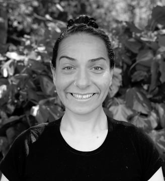 Ebru Tütek, Tai Ji and Qi Gong instructor at WDP Türkiye, smiling outdoors in a forest setting.