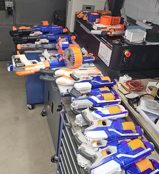 a bunch of nerfet guns are lined up on a table