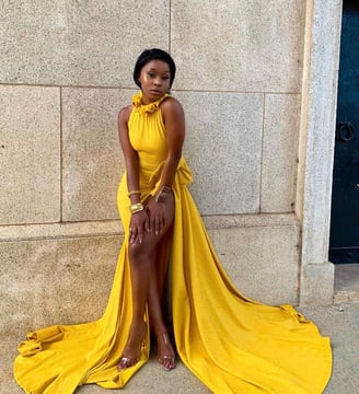 Efia Odo in a gorgeous yellow overall dres.