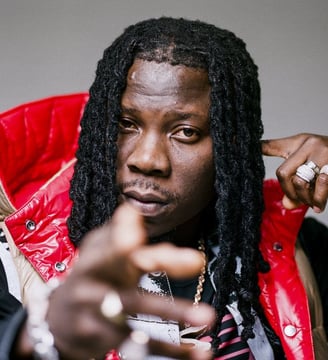 Stonebwoy in a multicolored vest.