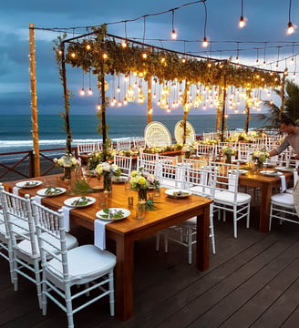 Wedding ceremony set up with hanging lights and flowers in the early evening