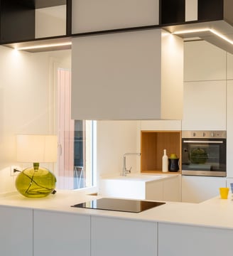 a kitchen with a white counter top and a vase with a vase on it