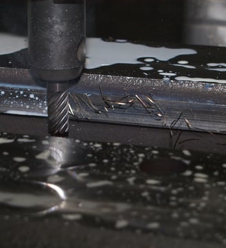 a machine that is cutting into a piece of metal