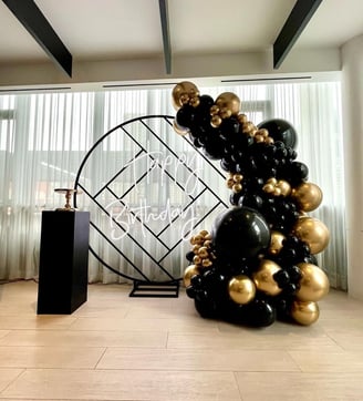 Black and gold balloon backdrop rental