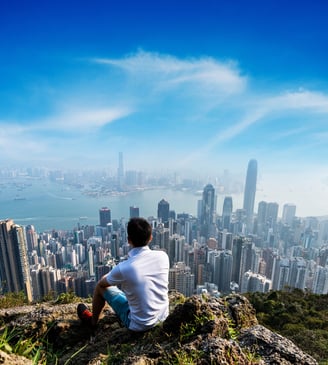 man-overlooking-hong-kong-skyline