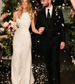 a bride and groom walking down the aisle of a wedding ceremony