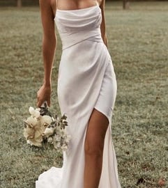 a woman in a white dress with a bouquet of flowers