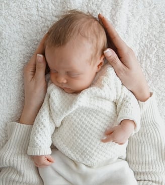 a newborn baby is sleeping in a white blanket