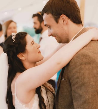 bride and groom smiling at each other during their first dance