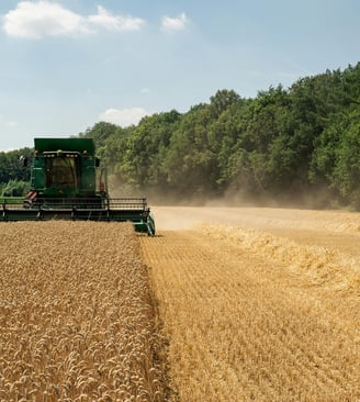 a combiner in a field with a tractor