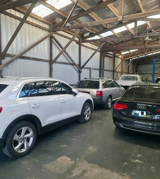 a group of cars parked in a workshop